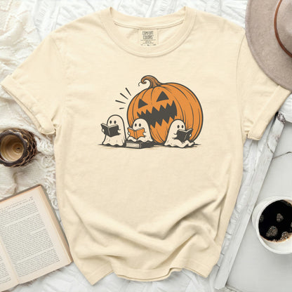 T-shirt with Comfort Colors tag featuring three ghosts reading books and a jack-o'-lantern.