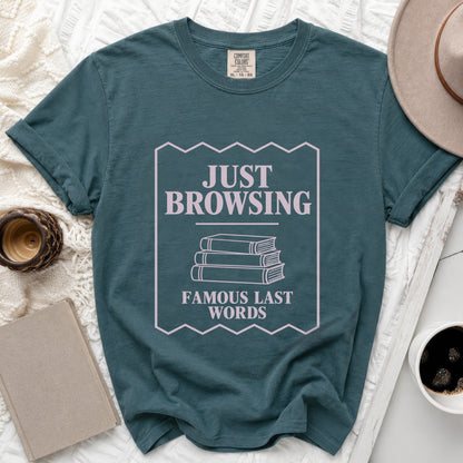 Teal t-shirt with "JUST BROWSING FAMOUS LAST WORDS" graphic and book illustration.
