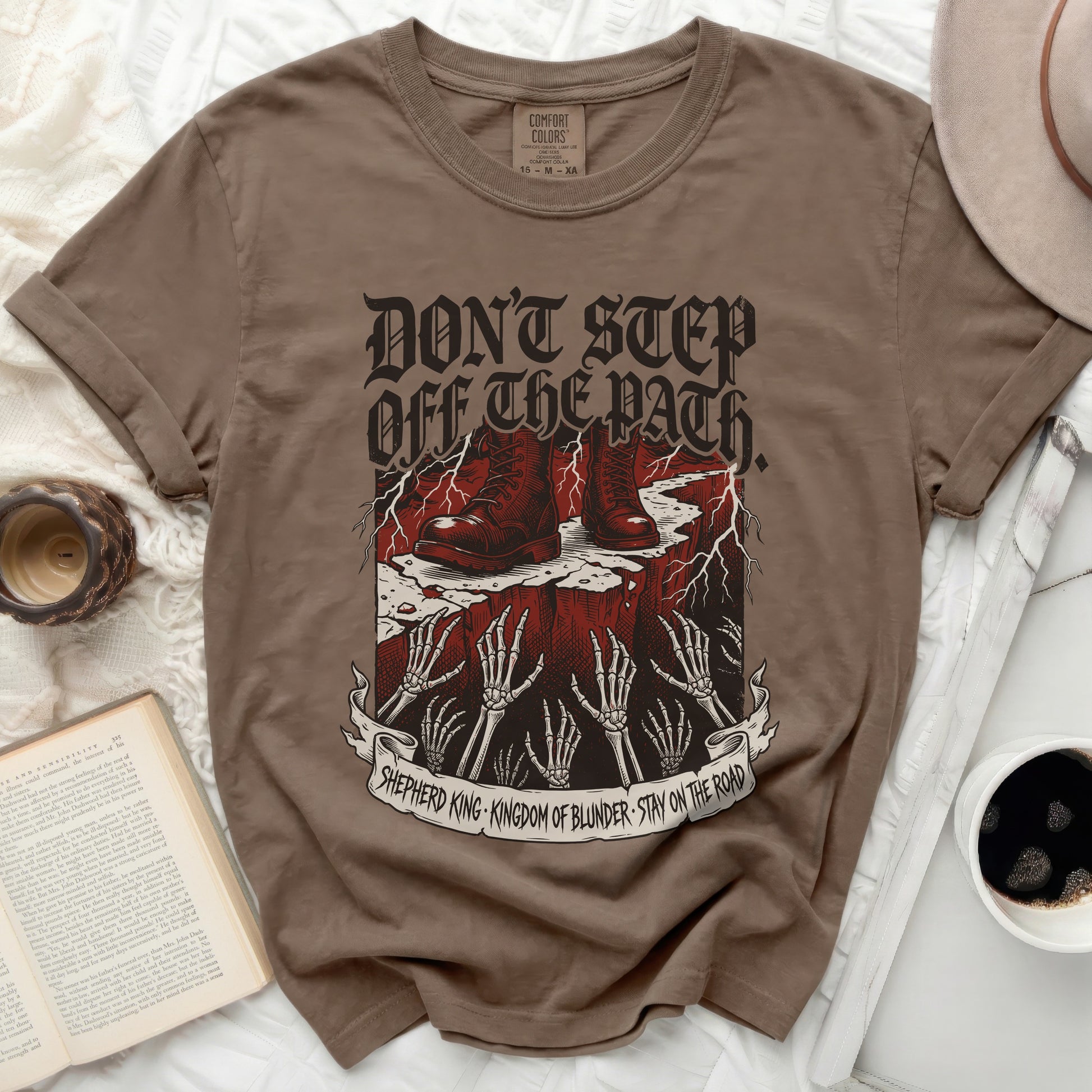 Brown t-shirt with "Don't Step Off The Path" and skull graphic.