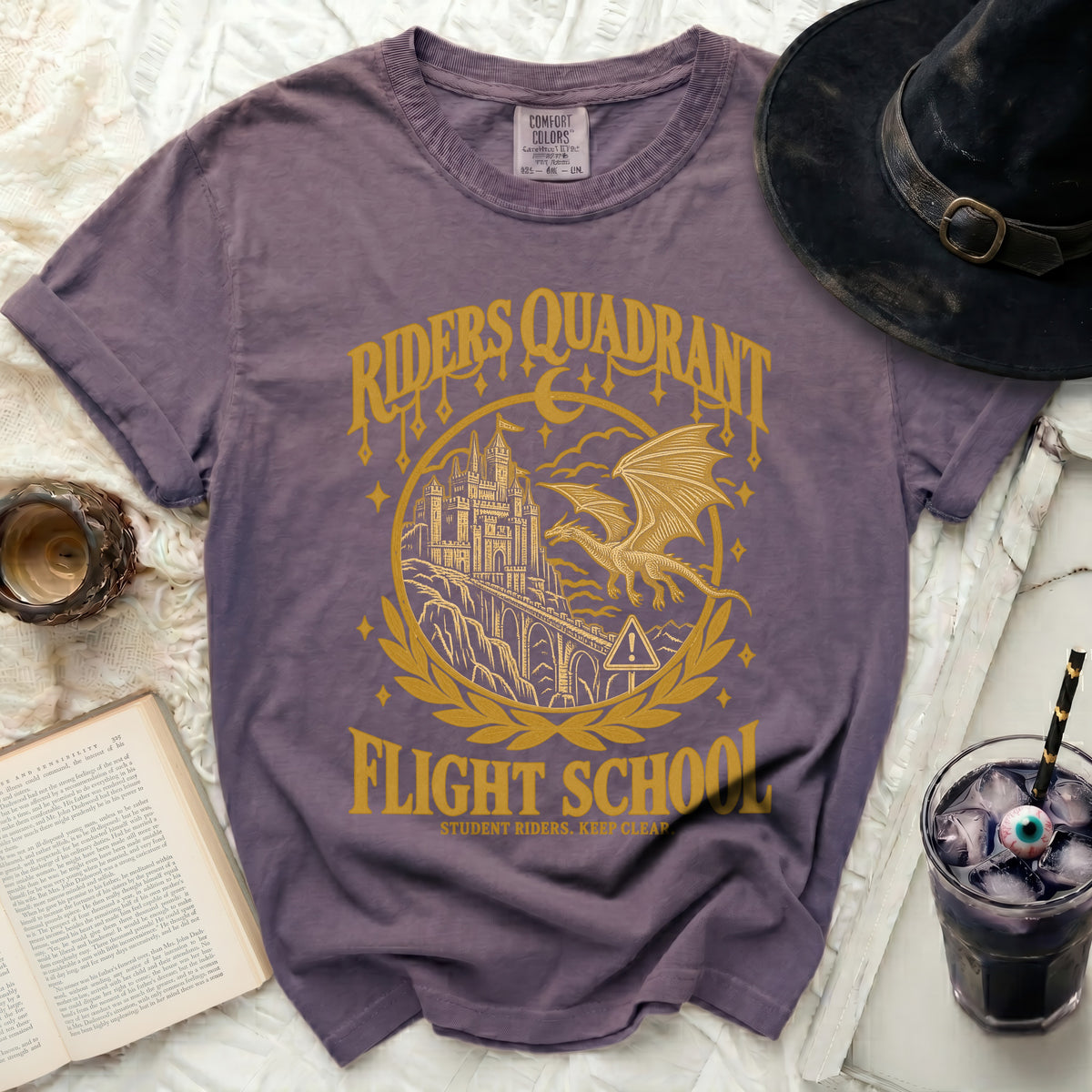 Purple t-shirt with "Riders Quadrant Flight School" text and dragon graphic.