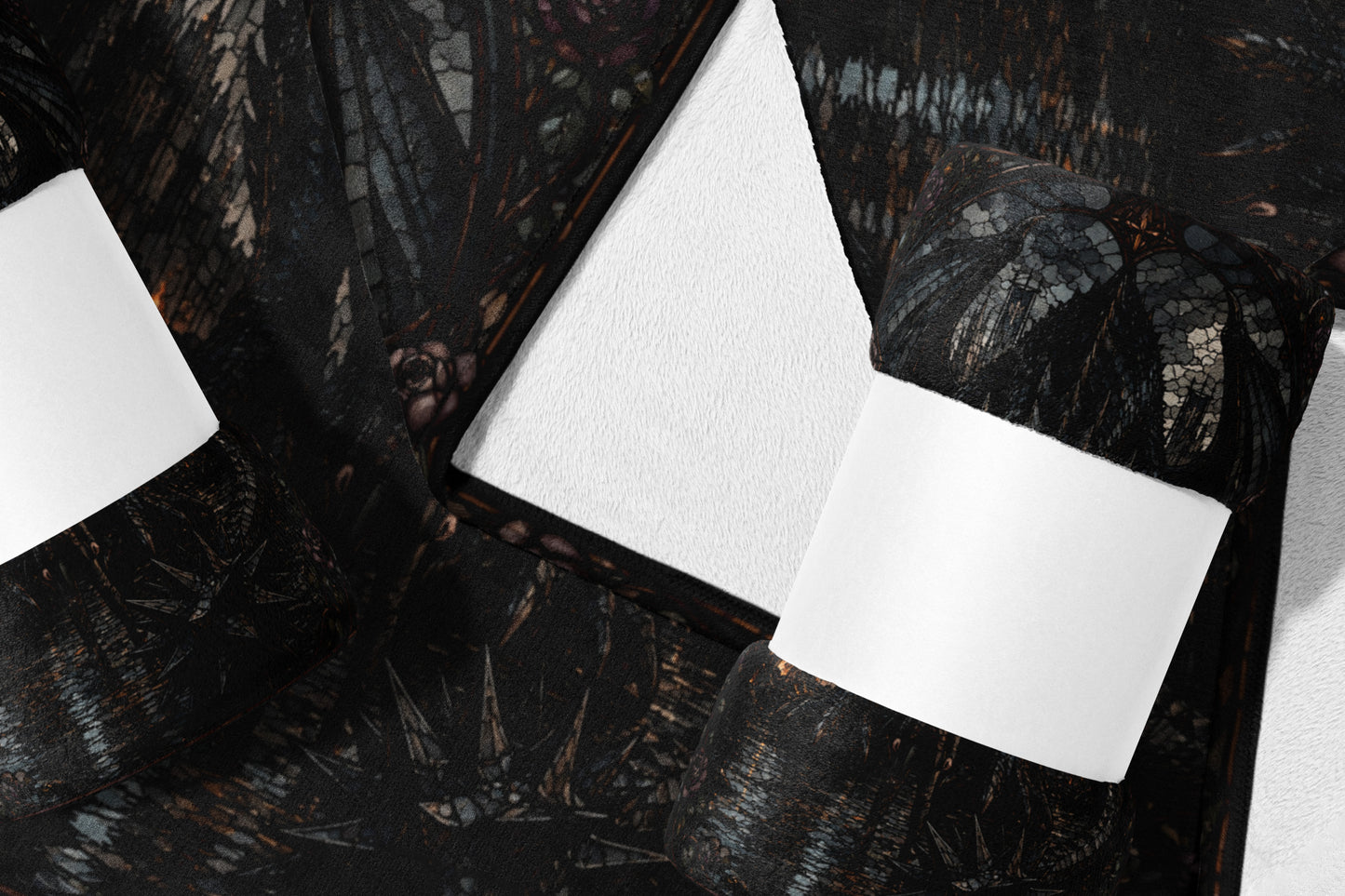 Dark patterned blanket with white paper band, folded on white surface.