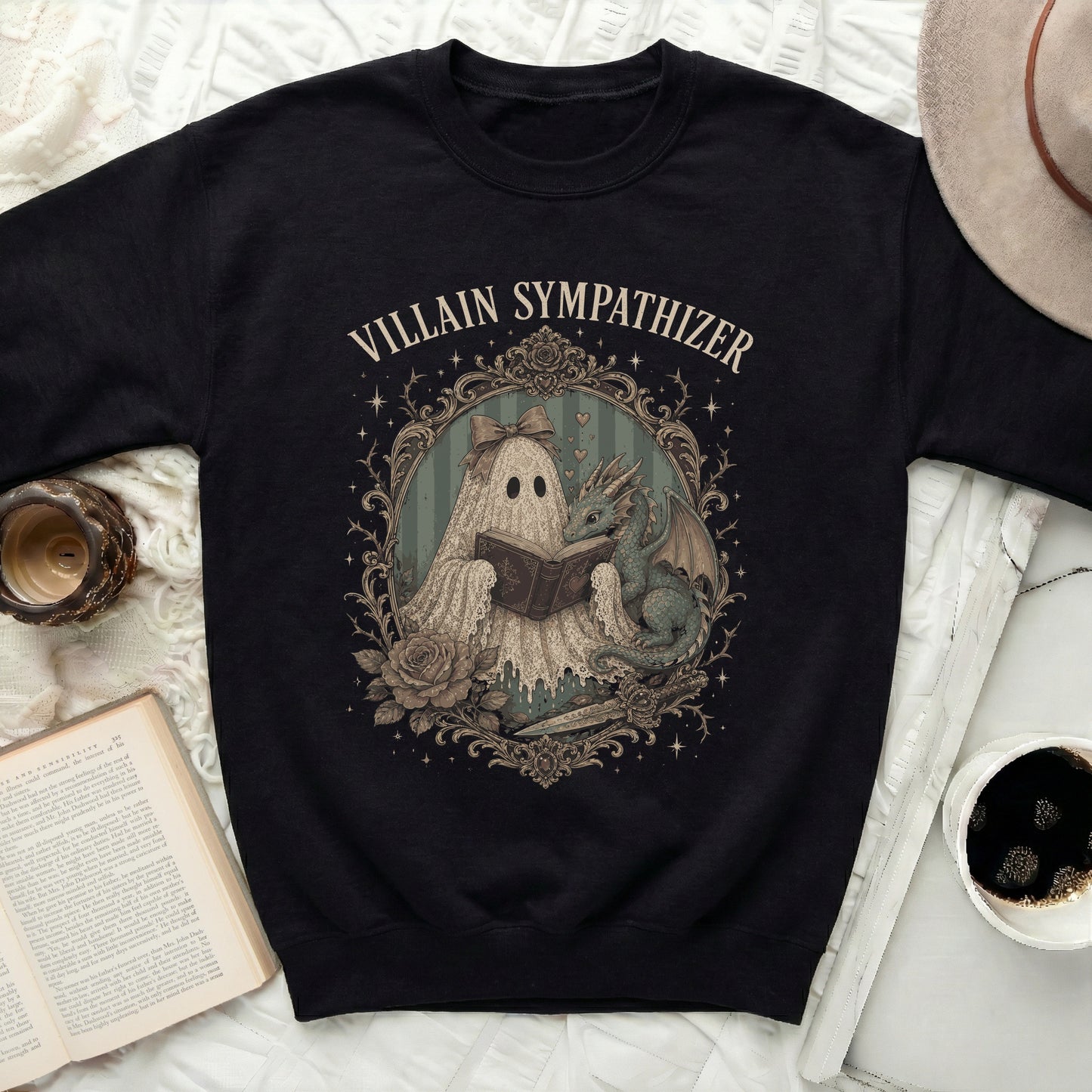 Black sweatshirt with a framed print of a ghost reading a book to a dragon.