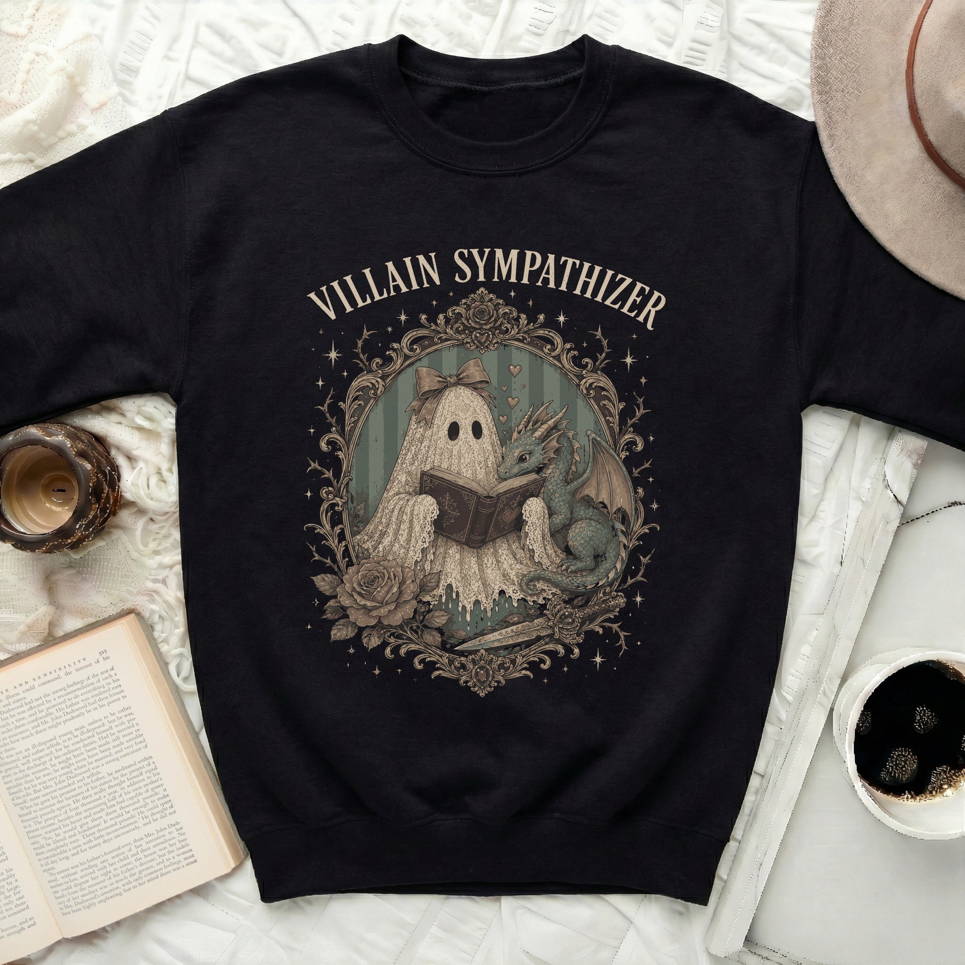Black sweatshirt with a framed print of a ghost reading a book to a dragon.