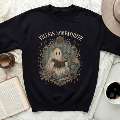 Black sweatshirt with a framed print of a ghost reading a book to a dragon.