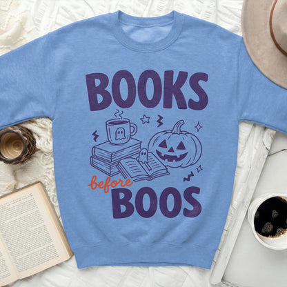 Blue sweatshirt with "Books before Boos" text and Halloween graphics.