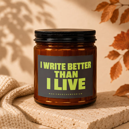 Glass candle with text "I WRITE BETTER THAN I LIVE" and "MAGICMERCH...".