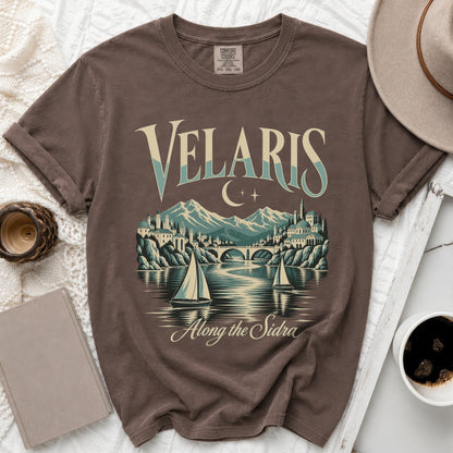 T-shirt graphic with "Velaris Along the Sidra" text, city, mountains, and sailboats.