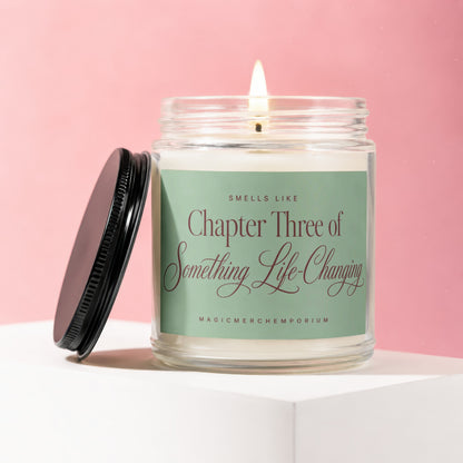 Lit candle in glass jar with black lid off to side, green label reads Chapter Three of Something Life-Changing.