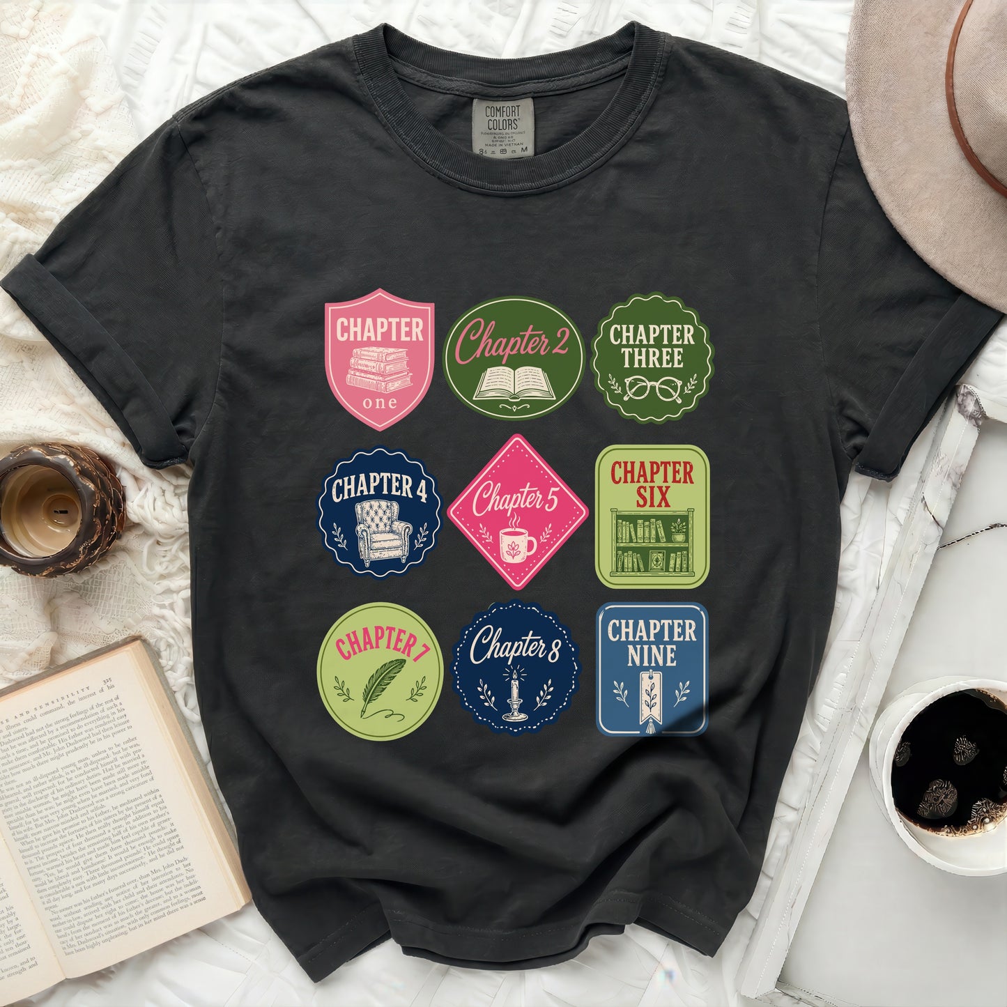 T-shirt with nine colorful circular book chapter badges.