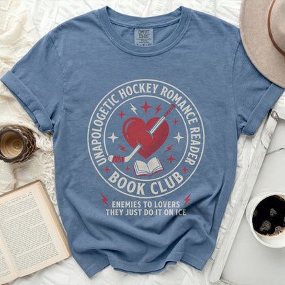 Blue t-shirt with "Unapologetic Hockey Romance Reader" and "Enemies to Lovers" text.