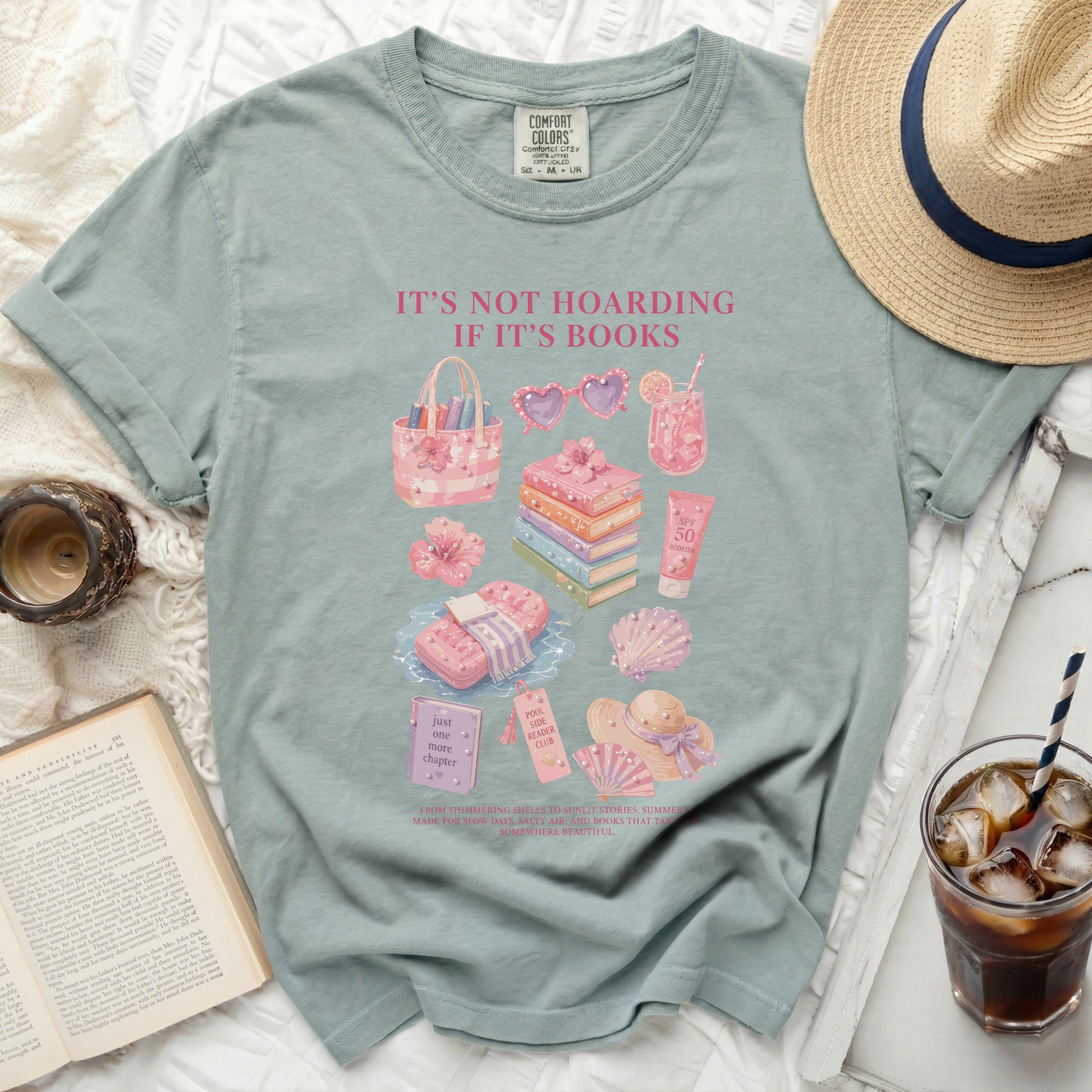 Green t-shirt with "It's Not Hoarding If It's Books" text and bookish illustrations.