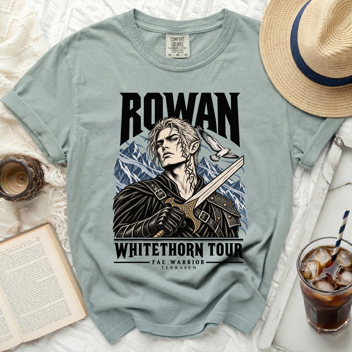 Light blue t-shirt with "Rowan Whithorn Tour Fae Warrior Terrasen" graphics.