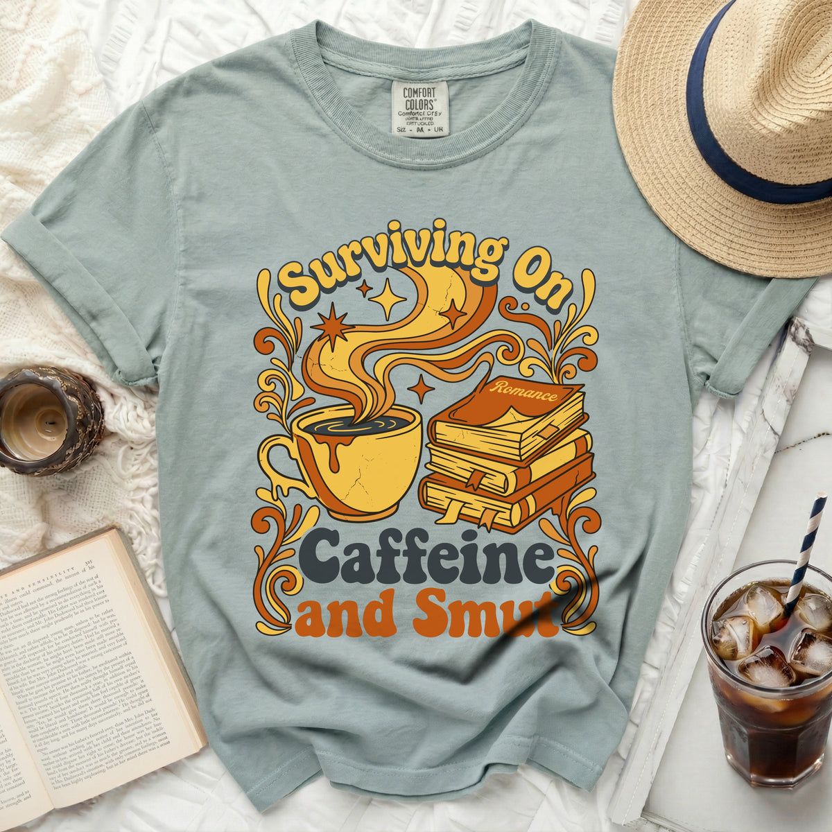 T-shirt with graphic: "Surviving On Caffeine and Smut" and a coffee cup.