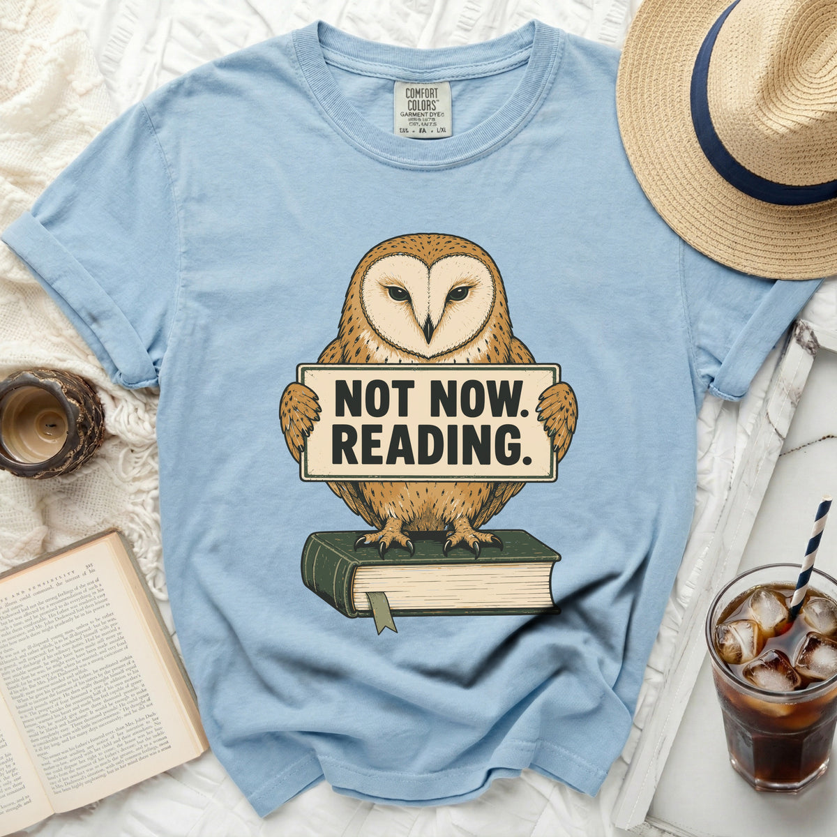 Light blue t-shirt with barn owl holding "NOT NOW. READING." sign.