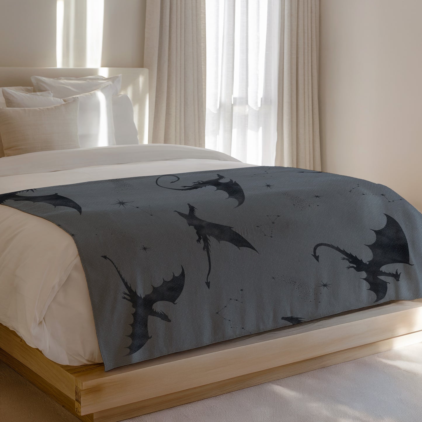 Gray throw blanket with multiple black dragon silhouettes and star patterns.