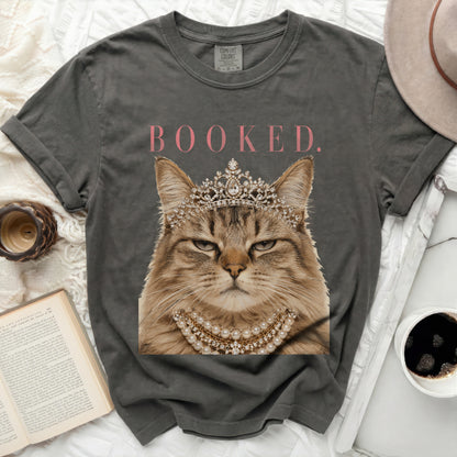 T-shirt with regal cat wearing crown and pearls, text "BOOKED."