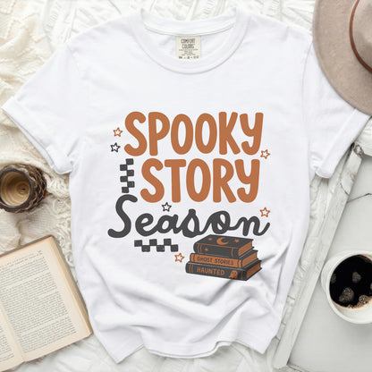 White t-shirt with "Spooky Story Season" and Halloween books graphic.