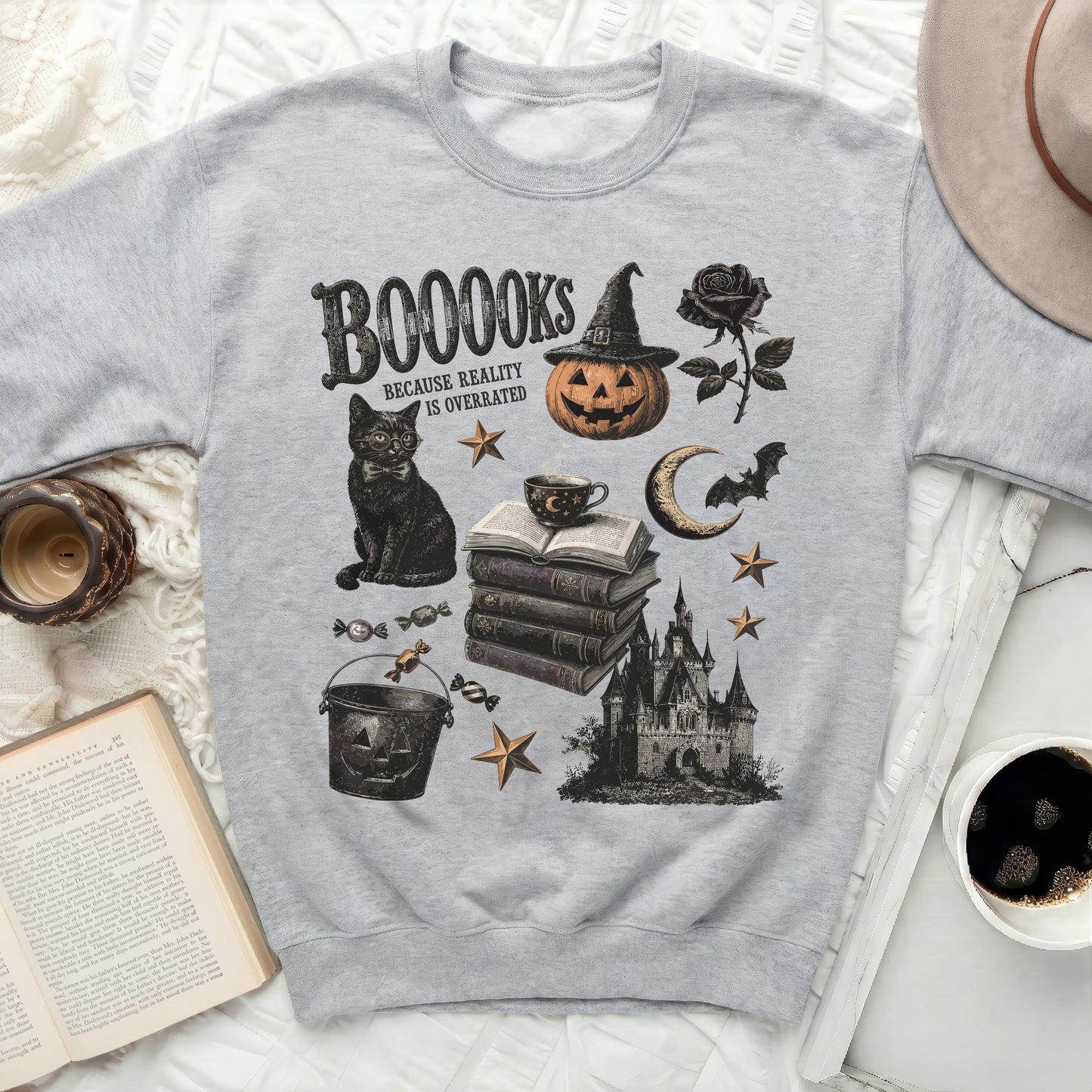 Sweatshirt with "BOOOOKS Because Reality Is Overrated" and Halloween-themed illustrations.