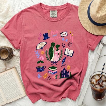 Pink t-shirt with Pride and Prejudice literary graphic and accessories, including a straw hat.