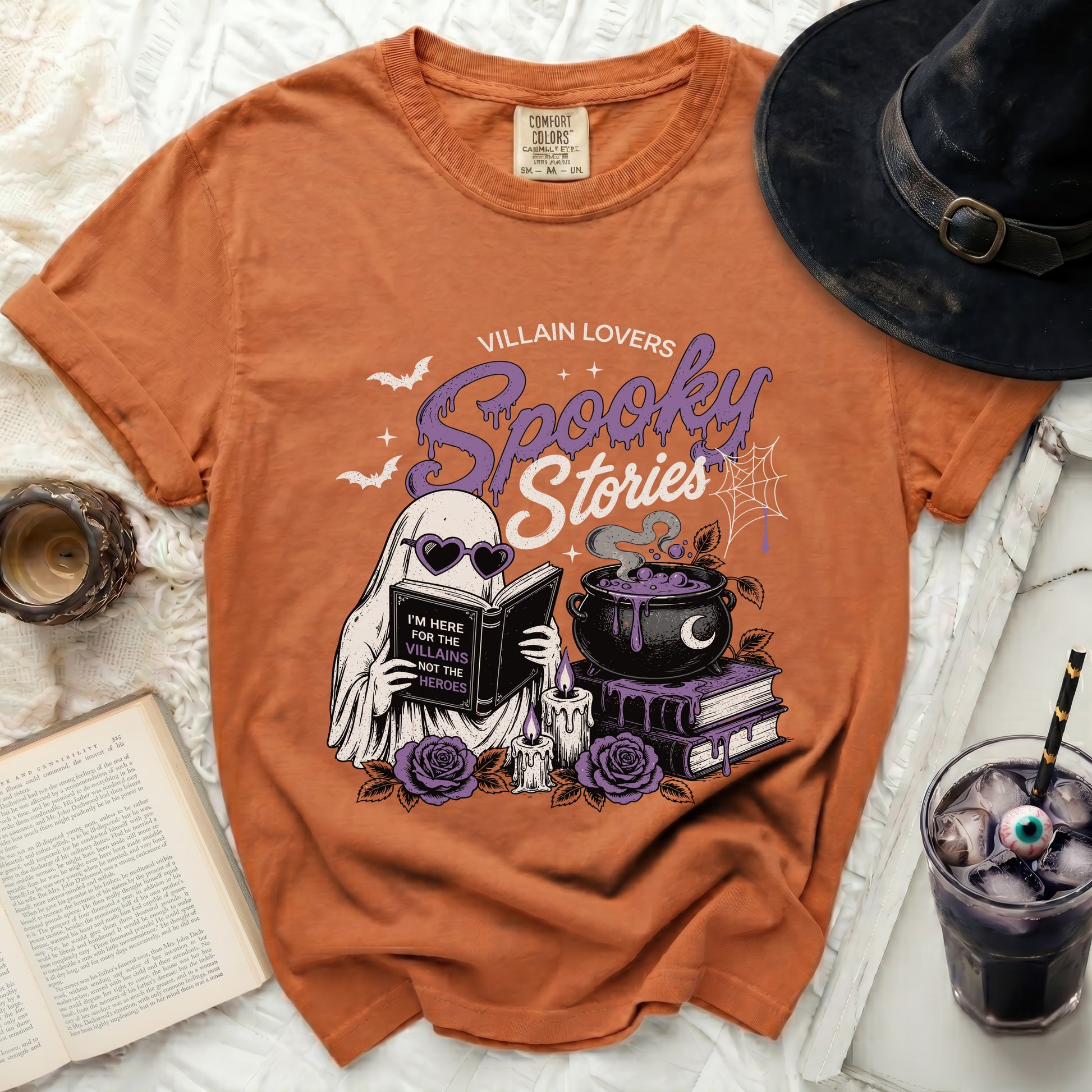Orange t-shirt with ghost reading a book for "Villain Lovers Spooky Stories."