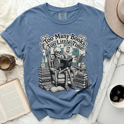 Skeleton reading a book with text "Too Many Books Too Little Time".