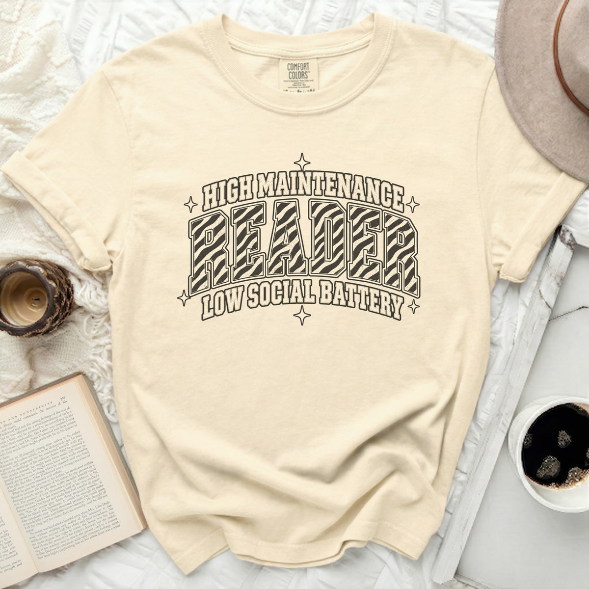 Cream t-shirt with "High Maintenance Reader" and "Low Social Battery" graphic.