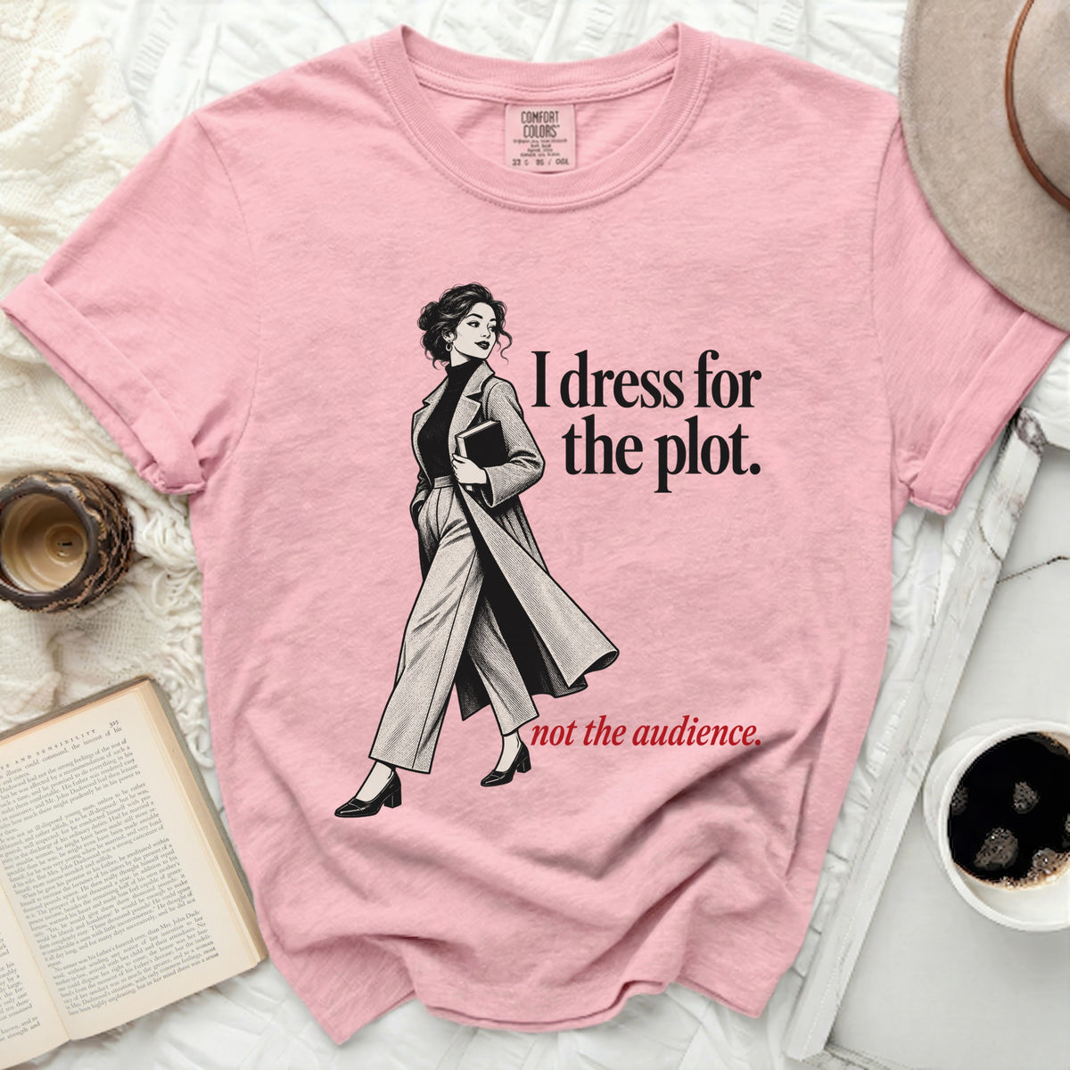 Pink t-shirt with illustration and text: "I dress for the plot. not the audience."