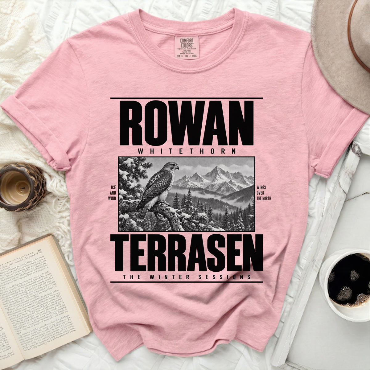 Pink t-shirt with black graphic: Rowan Whitethorn, hawk, mountains, and "Terrasen The Winter Sessions".