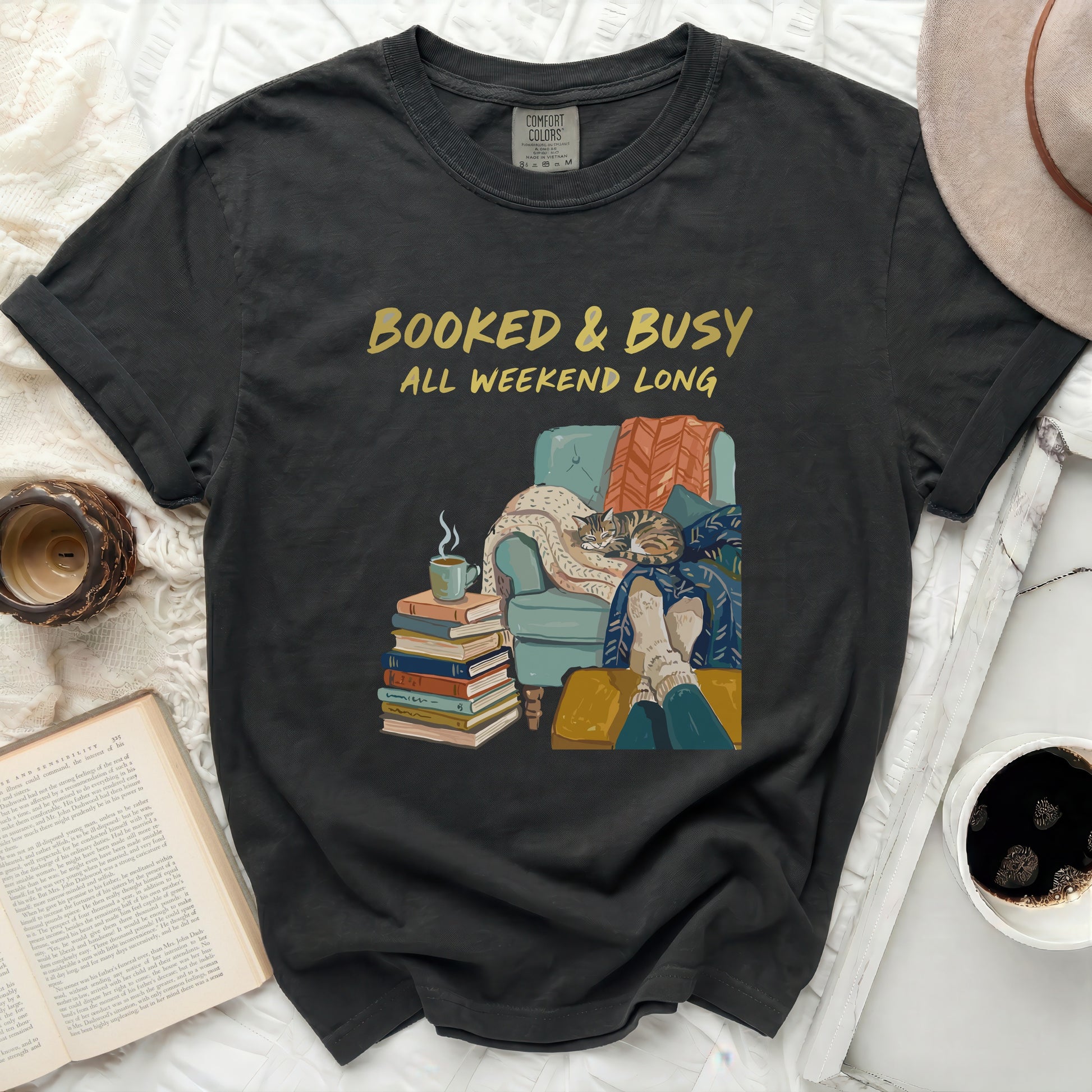 Black t-shirt with "Booked & Busy All Weekend Long" text and illustration.