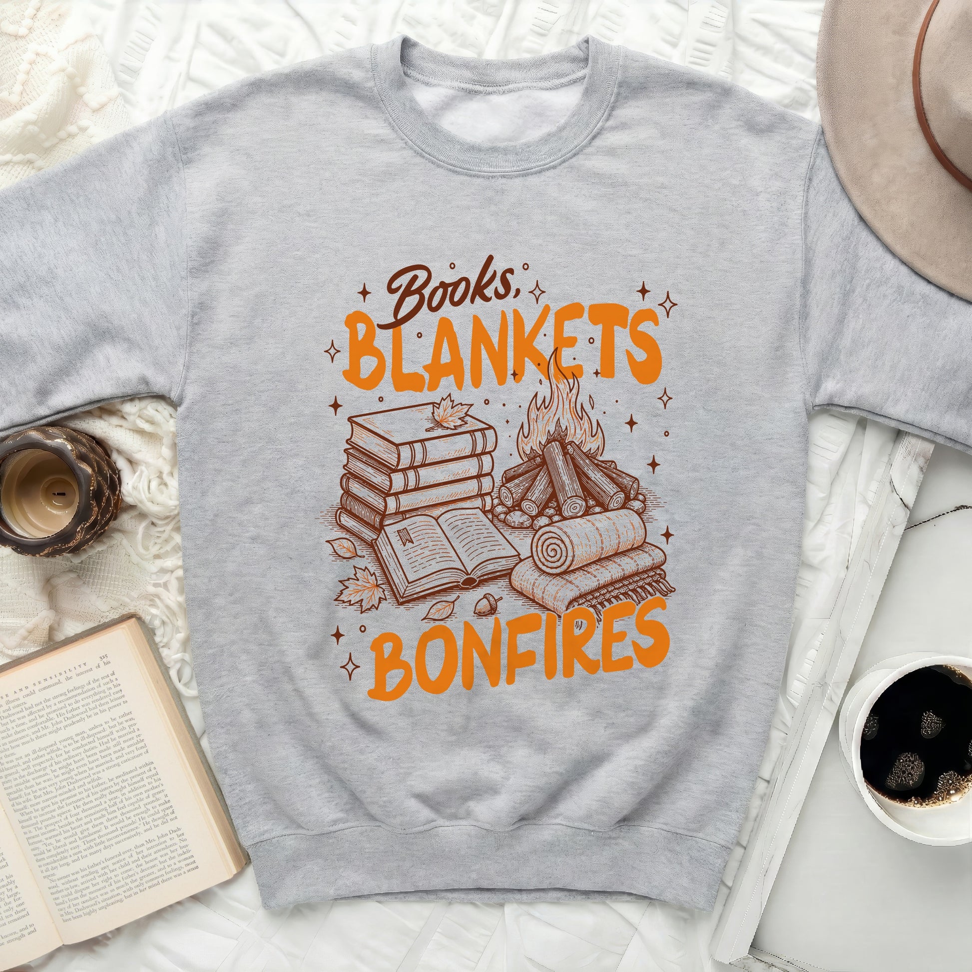 Gray sweatshirt with the text "Books, Blankets, Bonfires" and illustrations.