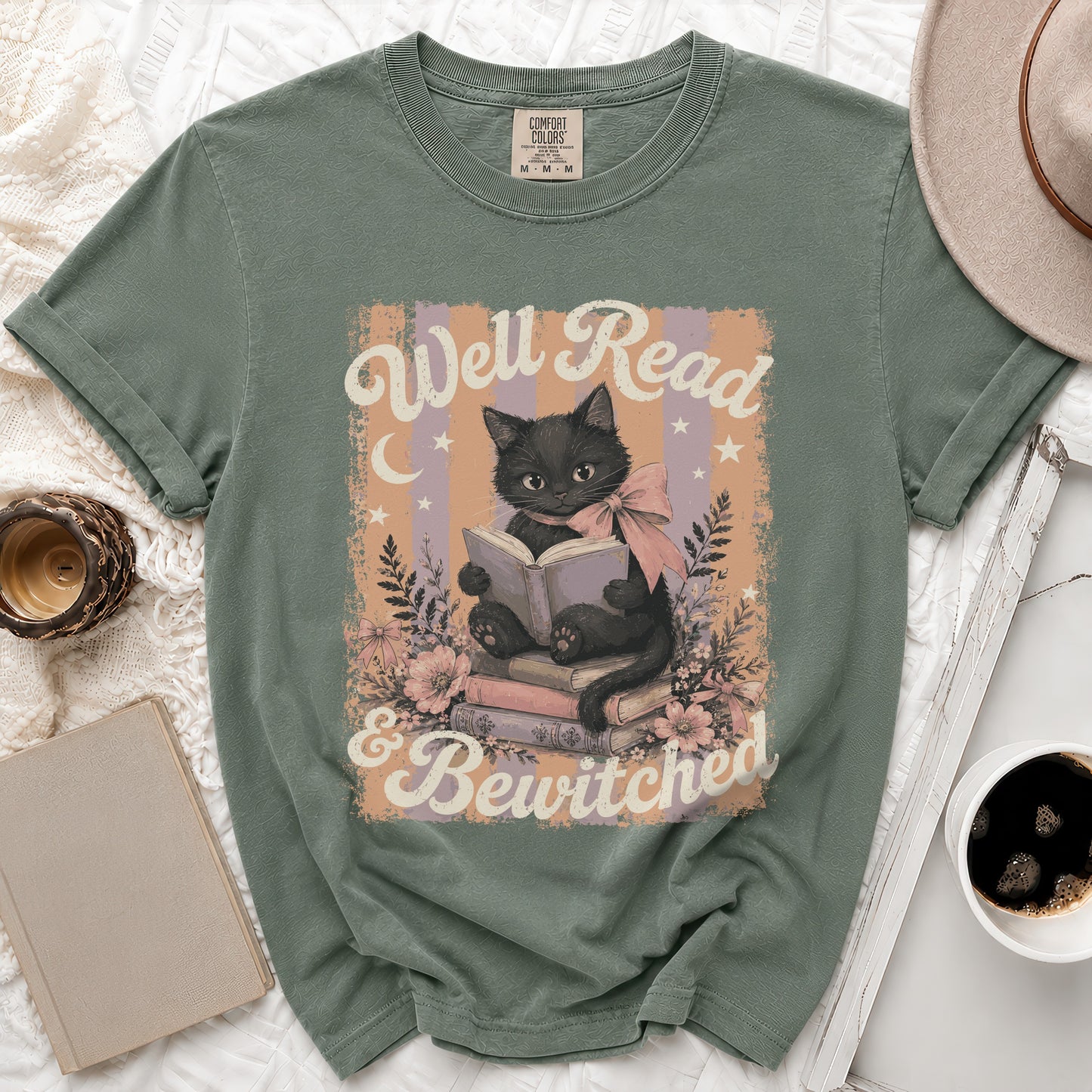 Green t-shirt with black cat reading on books, saying: Well Read & Bewitched.