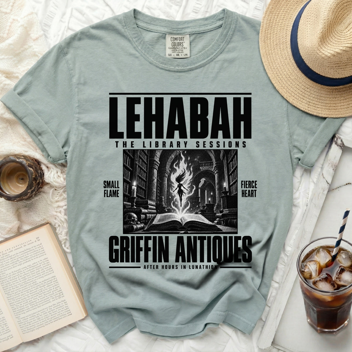 Pale green t-shirt with "LEHABAH THE LIBRARY SESSIONS" and dark illustration.