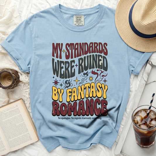 Light blue t-shirt with "MY STANDARDS WERE RUINED BY FANTASY ROMANCE" text.