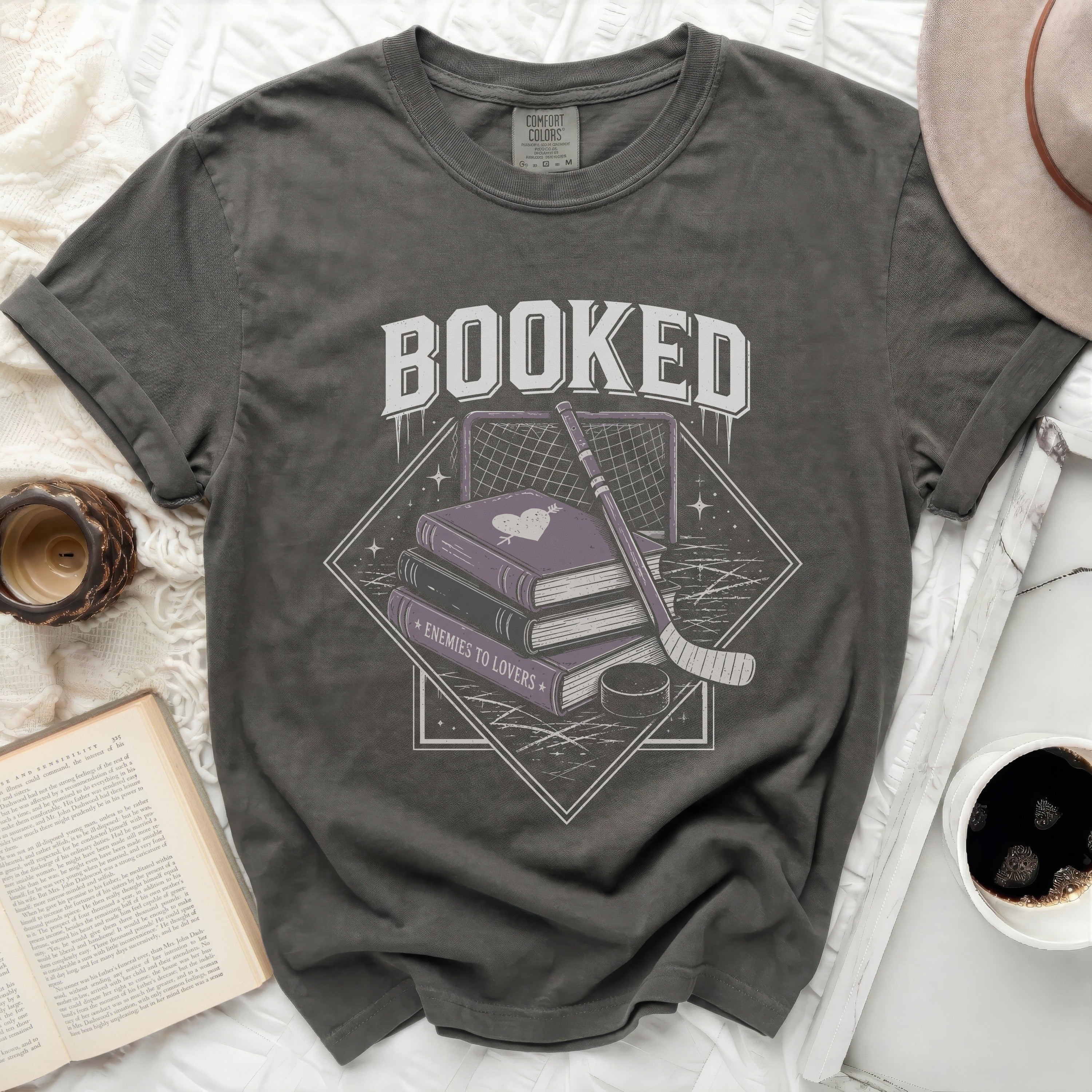 Book-themed graphic on a dark grey t-shirt with 