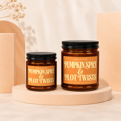 Two amber jar candles with "Pumpkin Spice & Plot Twists" labels.