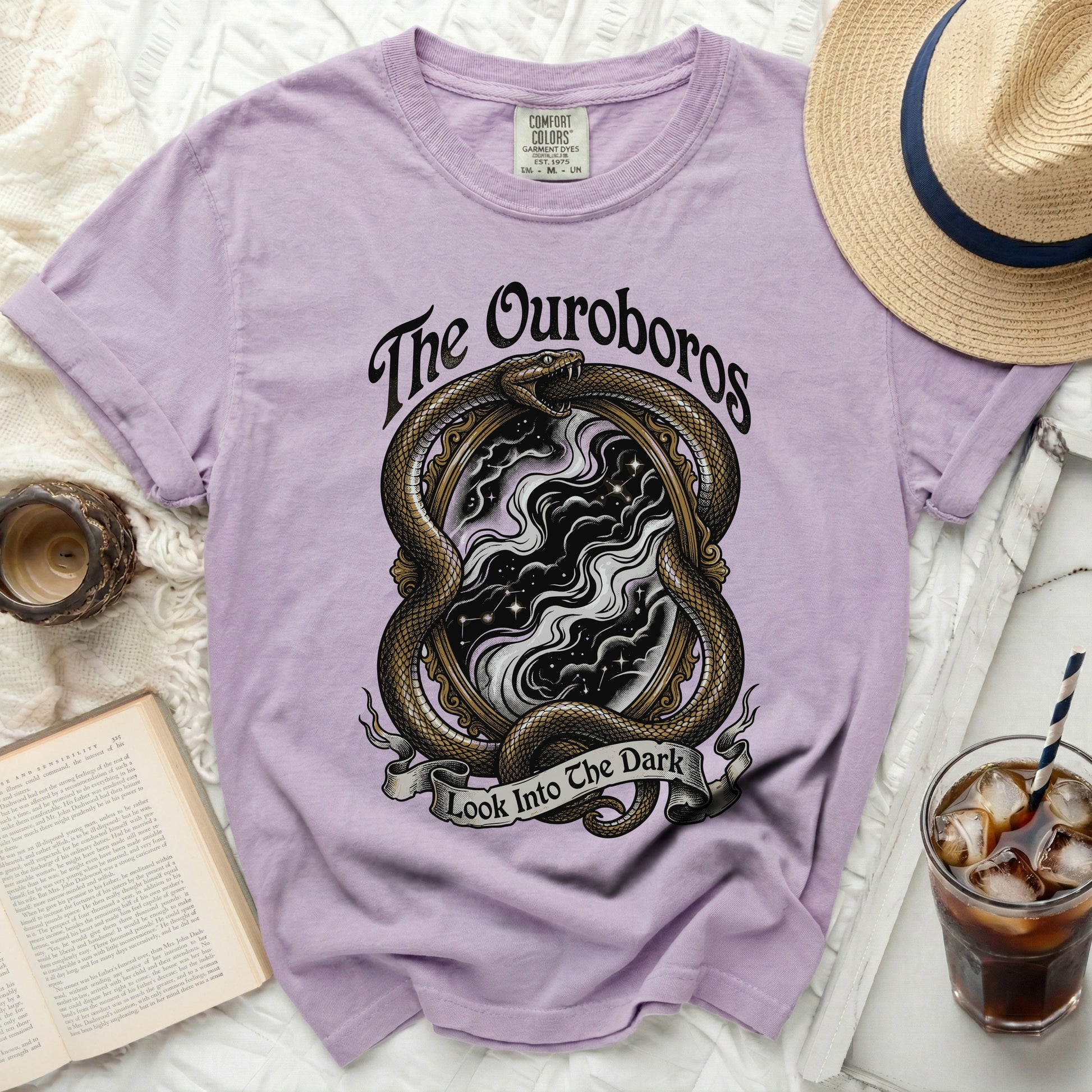 Lavender t-shirt with snake, mirror, and text "The Ouroboros Look Into The Dark".
