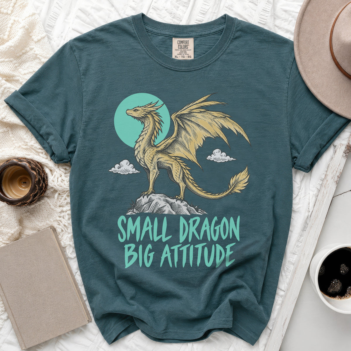 Teal t-shirt with a yellow dragon graphic and the text "SMALL DRAGON BIG ATTITUDE".