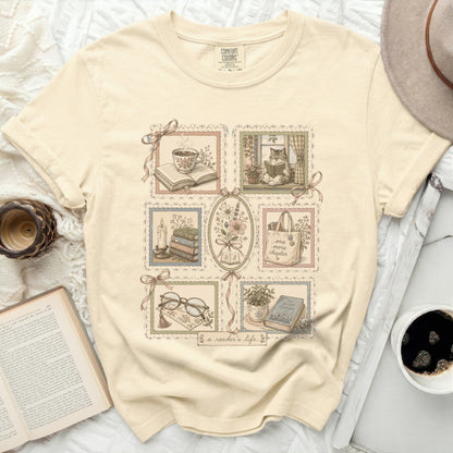 Cream t-shirt with framed literary illustrations and "a reader's life" text.