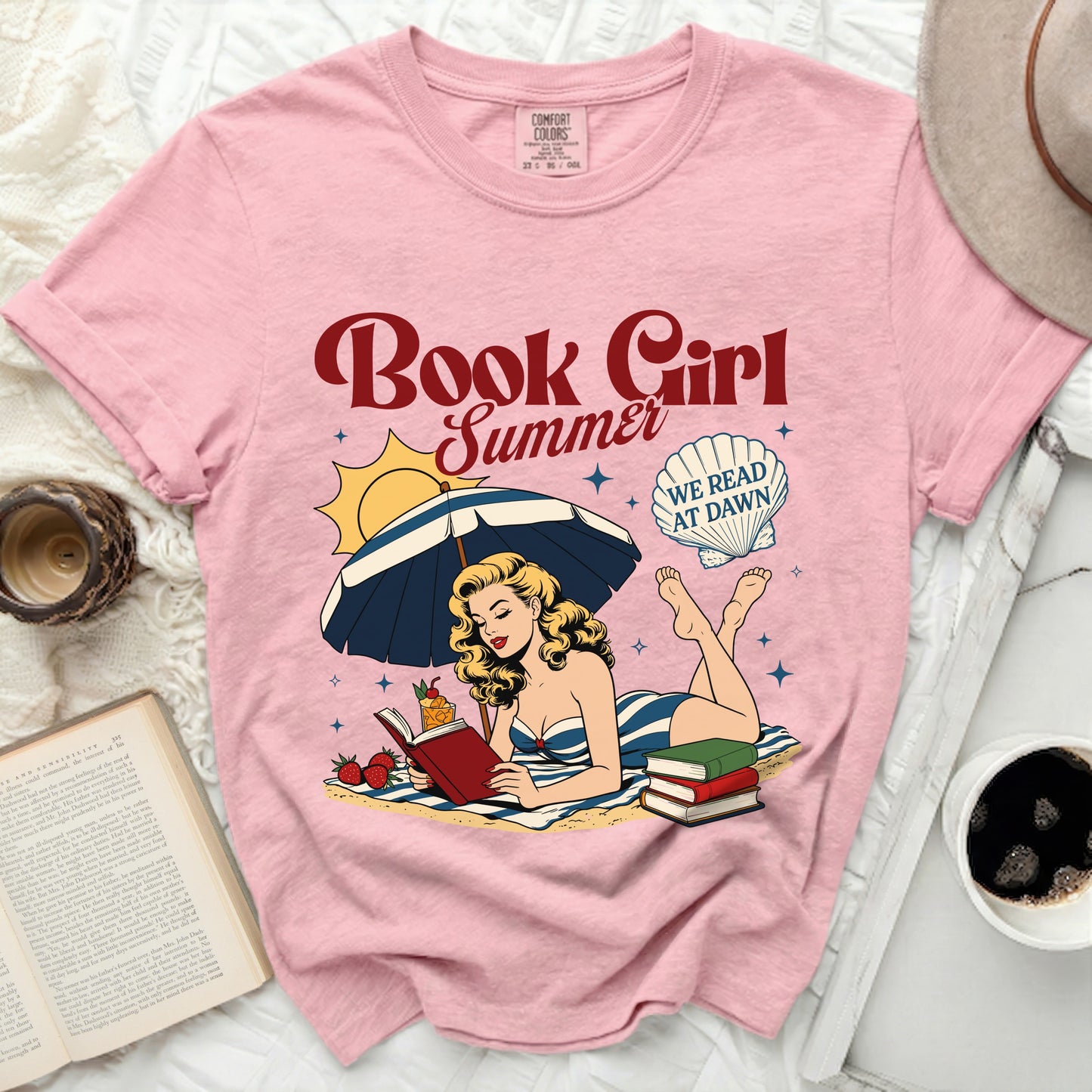 Pink t-shirt with "Book Girl Summer" graphic and a woman reading on the beach.