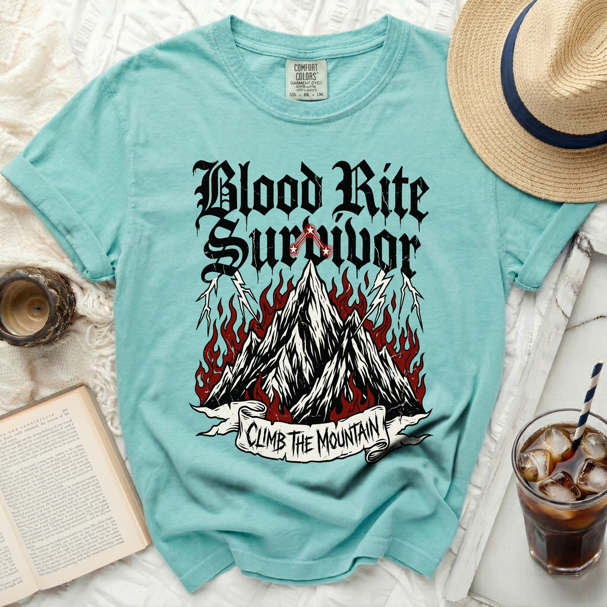Teal t-shirt with "Blood Rite Survivor Climb The Mountain" graphic.