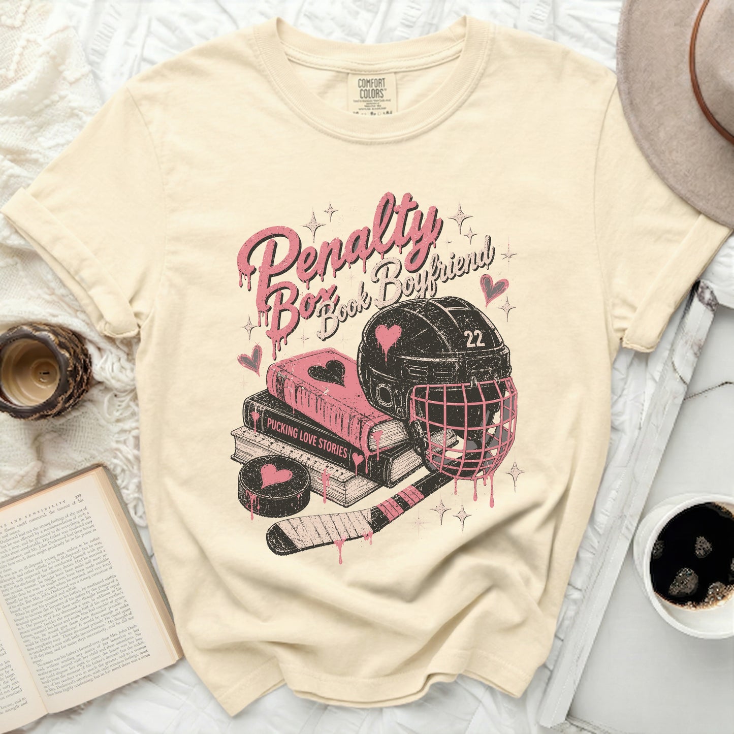 T-shirt with "Penalty Book Boyfriend" text, hockey gear, and books.