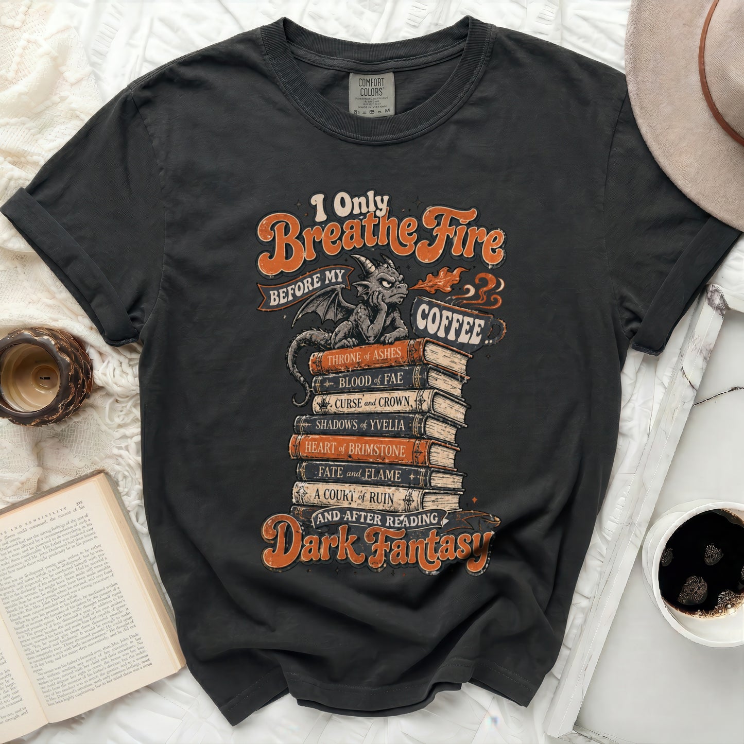 Dark fantasy t-shirt with a stack of books and "I Only Breathe Fire Before My Coffee" text.