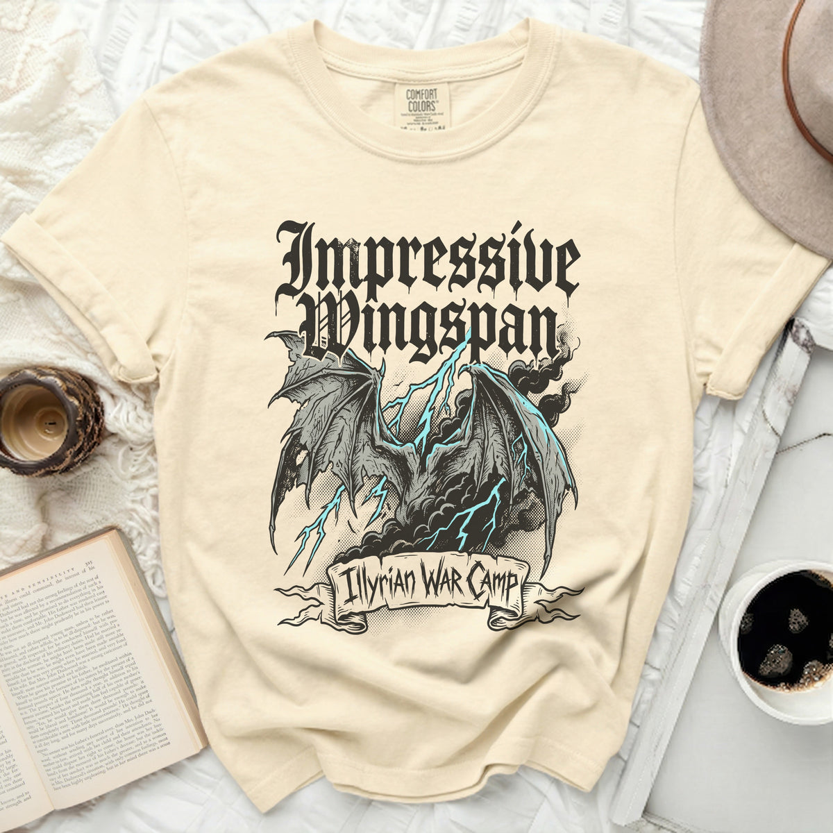 Cream t-shirt with gothic dragon graphic and "Impressive Wingspan" text.