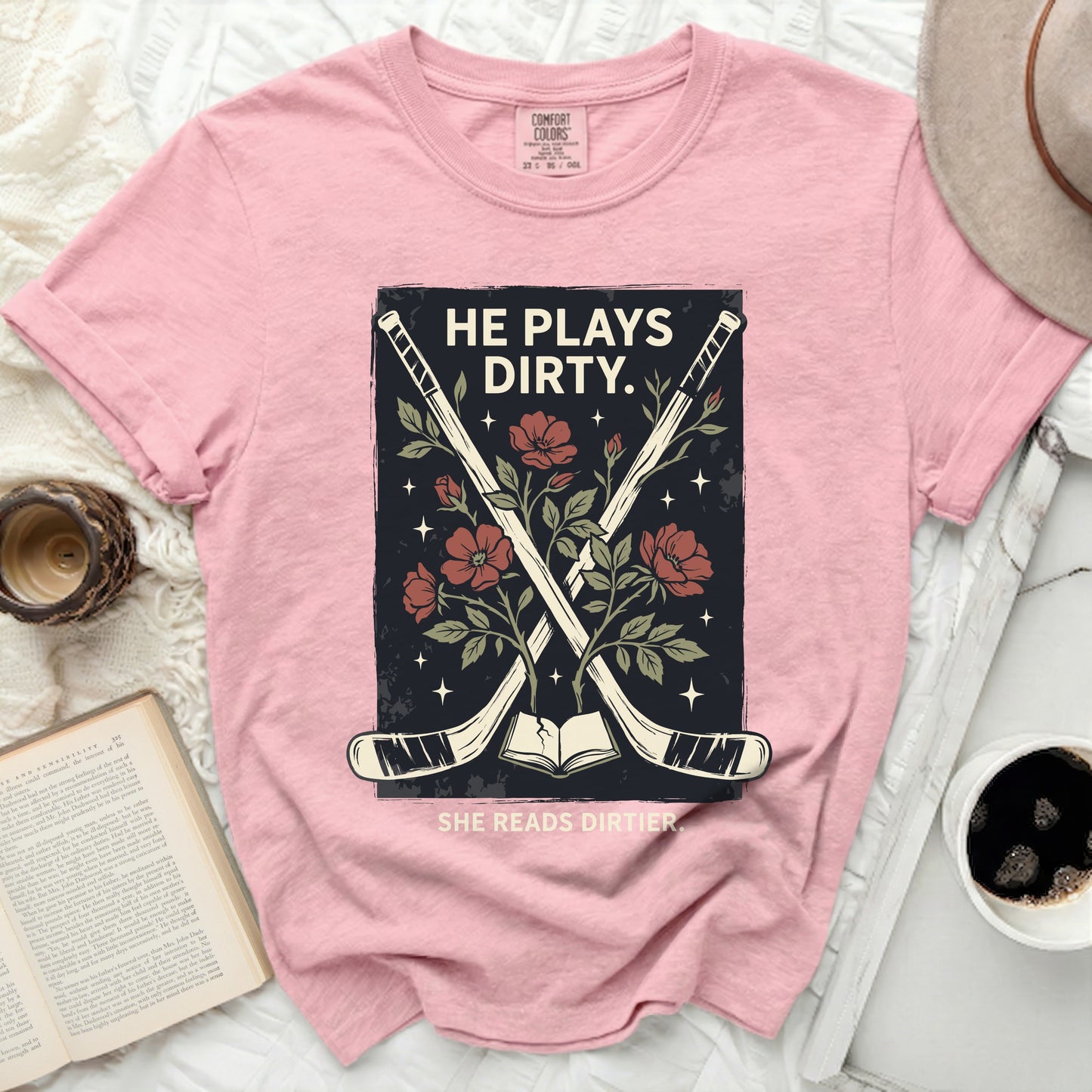 Pink t-shirt with hockey sticks, flowers, and text.