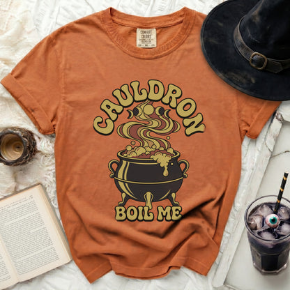 Orange t-shirt with "CAULDRON BOIL ME" text and a bubbling cauldron graphic.