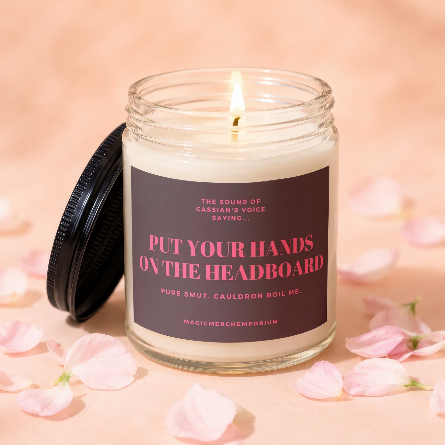 Glass candle with phrase "Put Your Hands On The Headboard" and "Magicmerchemporium" on label.
