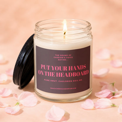 Glass candle with phrase "Put Your Hands On The Headboard" and "Magicmerchemporium" on label.