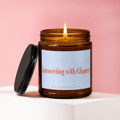 Amber candle with lit wick, labeled "Introverting with Chapters" and "MagicMerchEmporium".