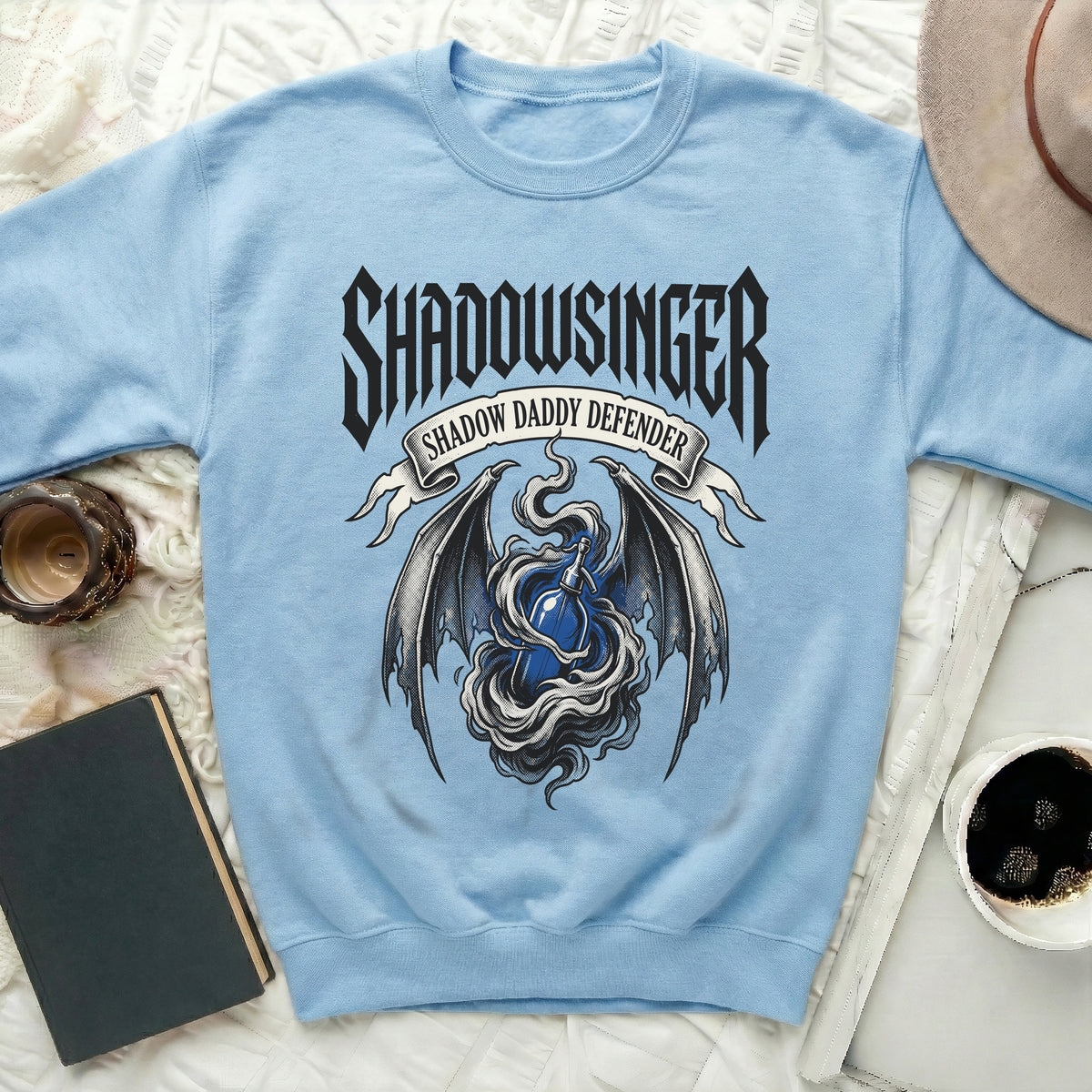 Light blue sweatshirt with "Shadowsinger" and "Shadow Daddy Defender" text.