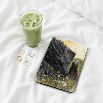 Painting of a dragon and a person in a field with a glass of matcha and rings.